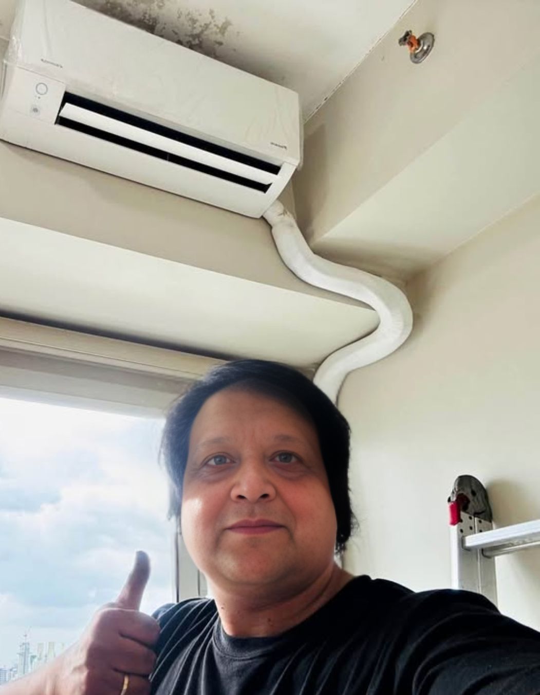 Kaushik Adhikari in front of a installed 1 Ton Split AC