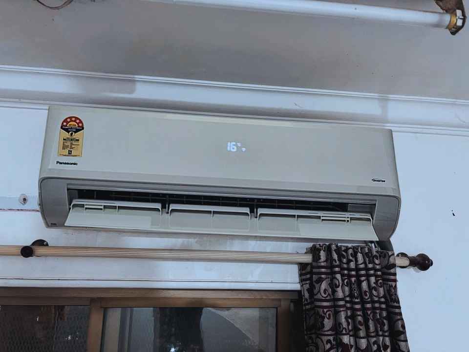 Panasonic CS/CU-NU18AKY5WX indoor AC unit with front flap and airflow through adjustable louvers and temperature set to 16°C.