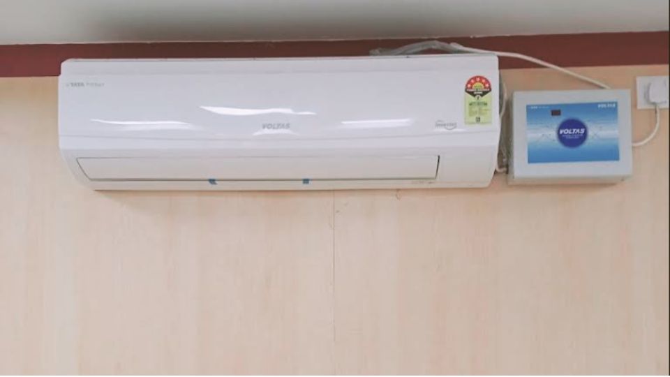 Voltas 1.5 Ton 5 Star Inverter Split AC (185V Vectra CAR) indoor unit wall installation near ceiling with connected wiring and Voltas control panel on the right